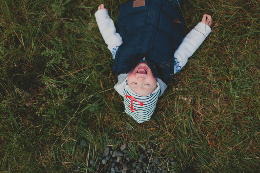 boy laughing on the grass