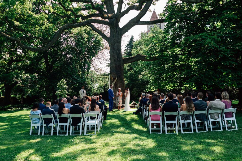 wide angle view of garden wedding ceremony at Spadina house in Toronto