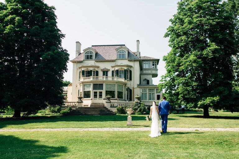 Outdoor garden wedding at the Spadina House; couple walking through the grounds