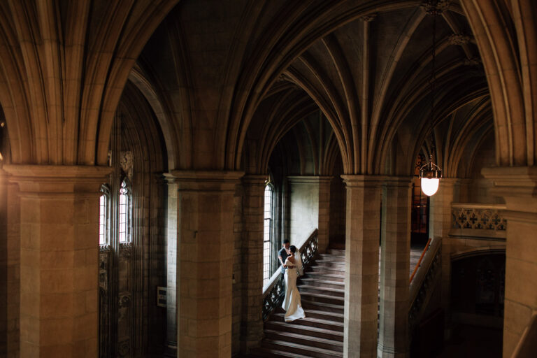 bride and groom standing on staircase in Knox College
